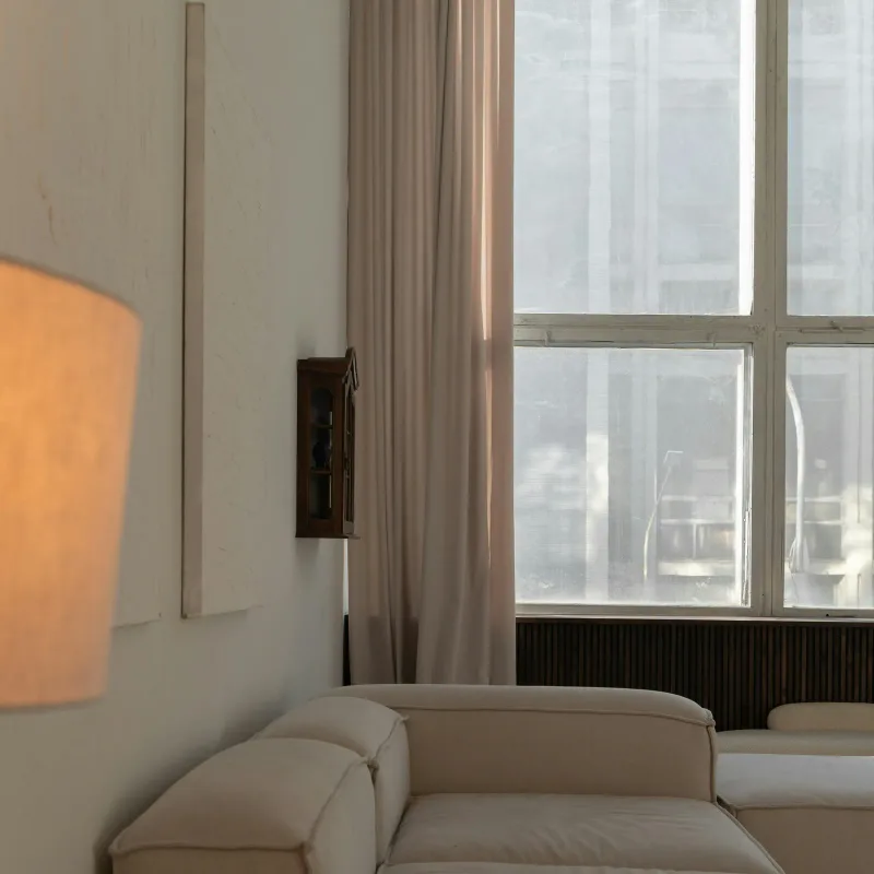 Bright living room with a lamp by the window