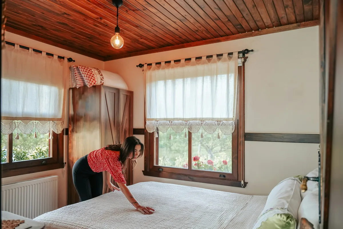 Morning exercise in a bedroom with a wooden ceiling